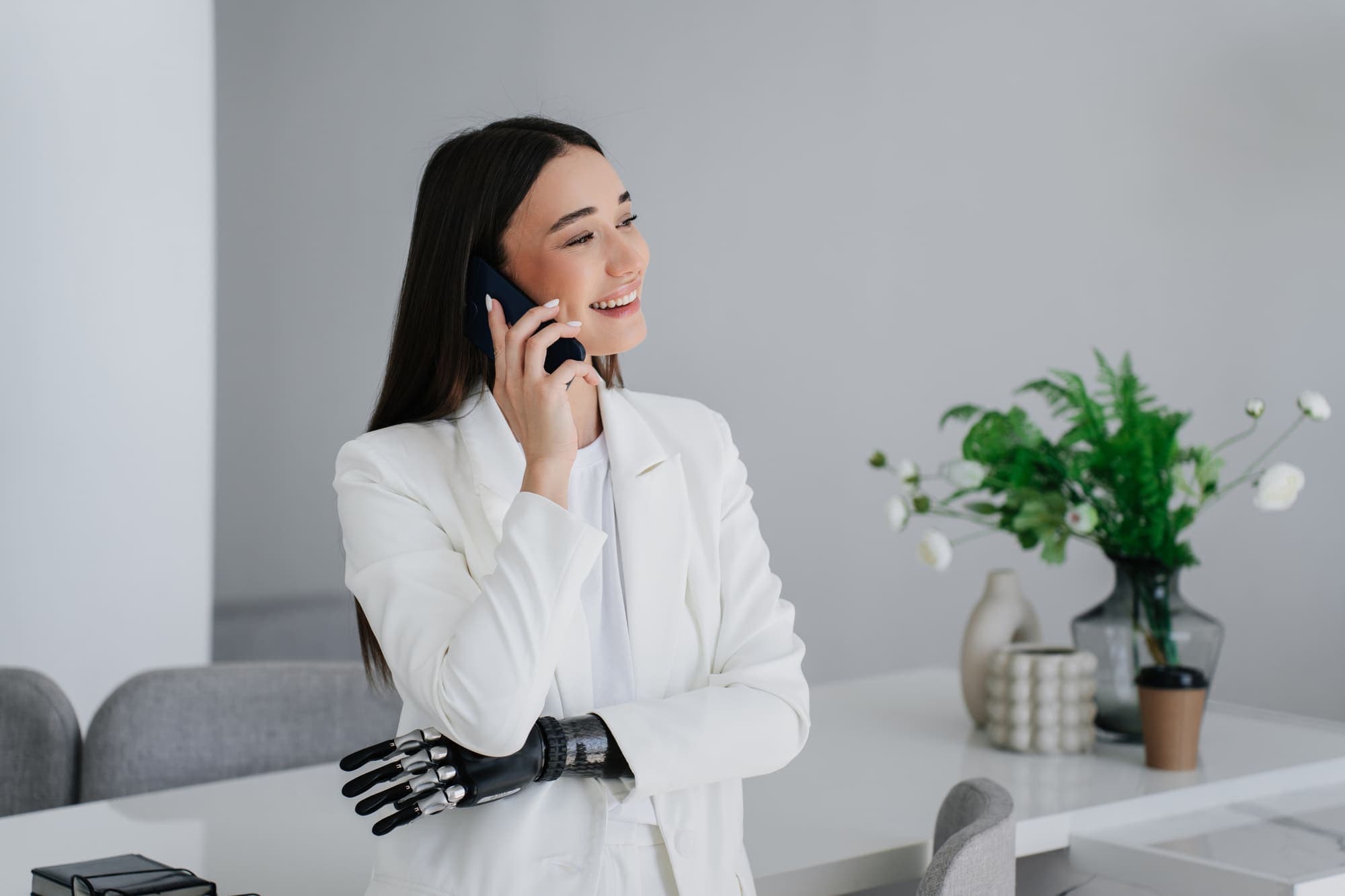 Frau nimmt lächelnd einen Anruf auf dem Handy entgegen